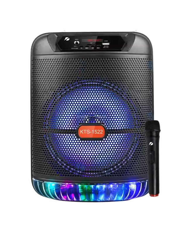 An image of a black portable wireless Bluetooth speaker with a blue light around the speaker area and a microphone in hand showing the product's scale.